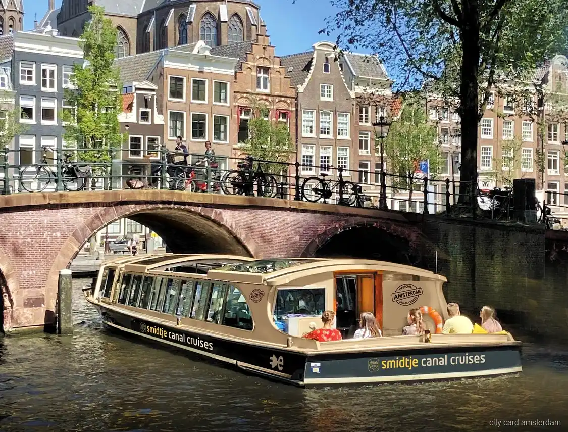 Amsterdam canal cruise electric boat with glass roof on the Prinsengracht